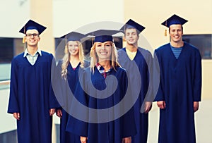 Group of smiling students in mortarboards photo