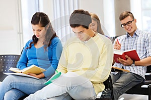 Group of smiling students with notebooks
