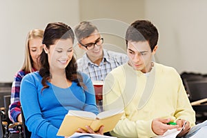 Group of smiling students with notebooks