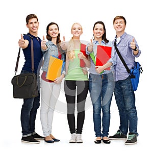 Group of smiling students showing thumbs up