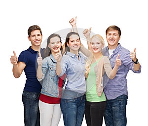 Group of smiling students showing thumbs up