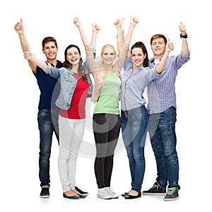 Group of smiling students showing thumbs up