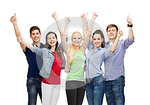 Group of smiling students showing thumbs up