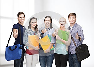 Group of smiling students showing thumbs up