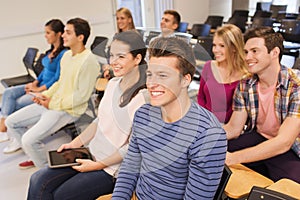 Group of smiling students with tablet pc