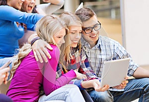 Group of smiling students with tablet pc