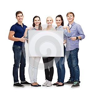 Group of smiling students with white blank board