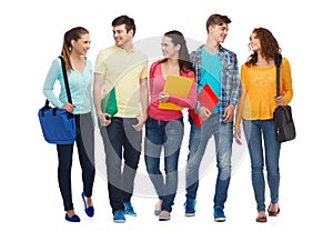 Group of smiling teenagers with folders and bags