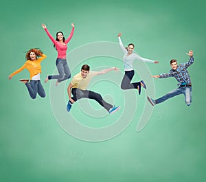 Group of smiling teenagers jumping in air