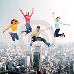 Group of smiling teenagers jumping in air