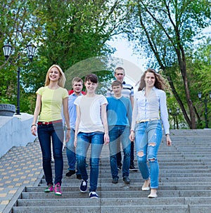 Group of smiling teenagers walking outdoors