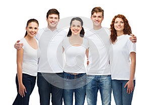 Group of smiling teenagers in white blank t-shirts
