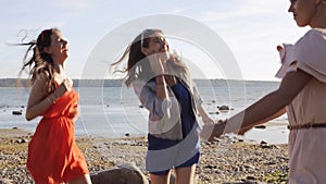 Group of smiling women or girls dancing on beach 30