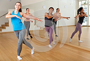 Group of smiling women training sport dance