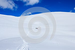 Group of snowboarders climbing snow mountain and blue sky