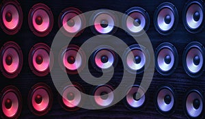 Group of sound speakers in neon light.