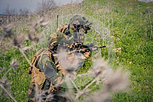 Group of special forces soldiers lurking in the grass