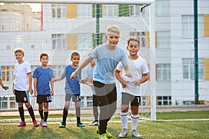 Group of sportive athletic boys playing football