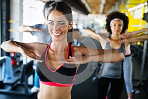 Group of sportive people in a gym training