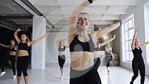 Group of sportive people training in a fitness class - caucasian group of athletes young women doing fitness or step