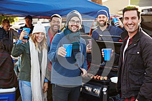 Group Of Sports Fans Tailgating In Stadium Car Park photo