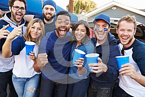 Group Of Sports Fans Tailgating In Stadium Car Park photo