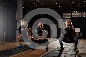 Group of sporty caucasian adults exercising in gym