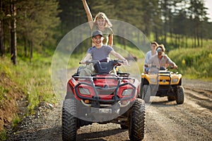 Group of sporty friends driving quads together photo
