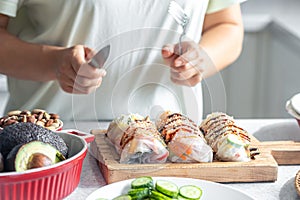 Group of spring rolls with rice paper filled with vegetables.