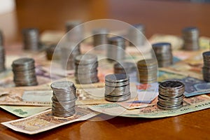 Group of stack currency coins and notes on table - Image