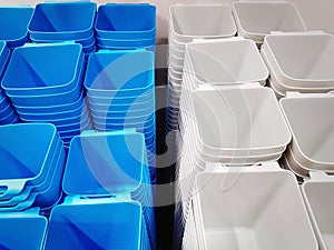 Group of Stacked White and Blue Plastic Containers for Sale
