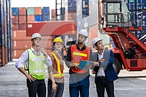 Group of staff worker standing and checking the containers box from cargo ship