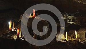 A group of stalagmites are illuminated in a cave