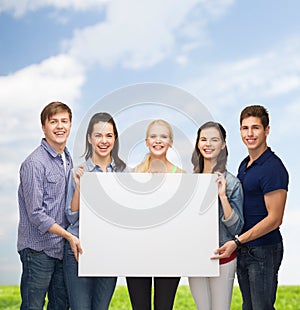 Group of standing students with blank white board