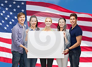 Group of standing students with blank white board