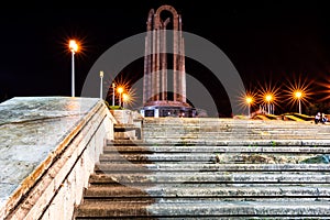 a group of steps leading up a stone building at night
