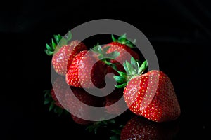 Group of strawberries with reflection