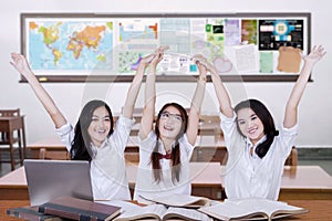 Group of student celebrating achievement in class