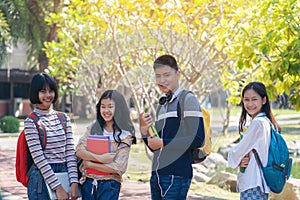 Group of student happy young people walking outdoors, Diverse Young Students Book Outdoors Concept