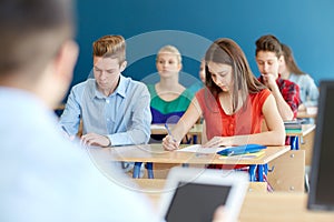 Group of students with books writing school test