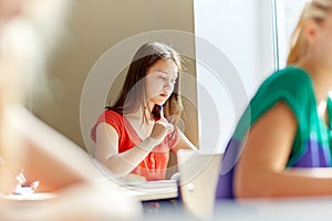 Group of students with books writing school test