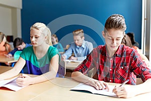 Group of students with books writing school test