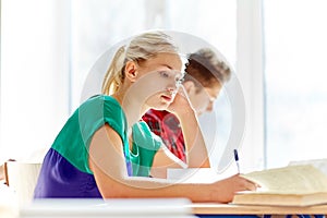 Group of students with books writing school test