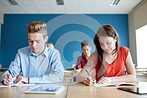 Group of students with books writing school test