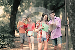 Group of students discussing exam questions standing in the Park