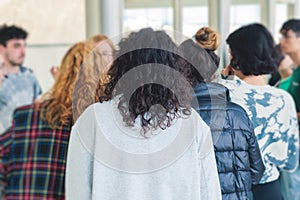 Group of students on excursion visit gallery museum with tour guide, a docent with a tourist adult visitors on an archaeology