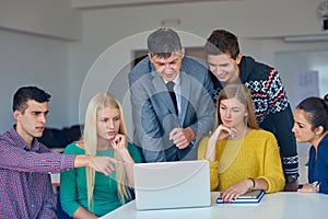 Group of students getting suppport from teacher