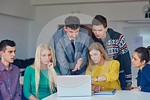 Group of students getting suppport from teacher