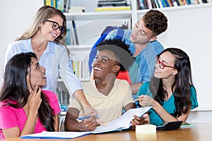 Group of students learning with female teacher