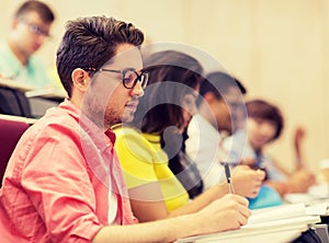 Group of students with notebooks in lecture hall